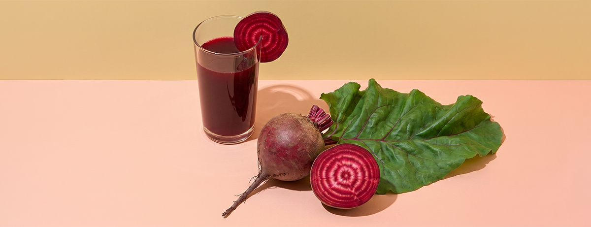 Beetroot juice on a peach background