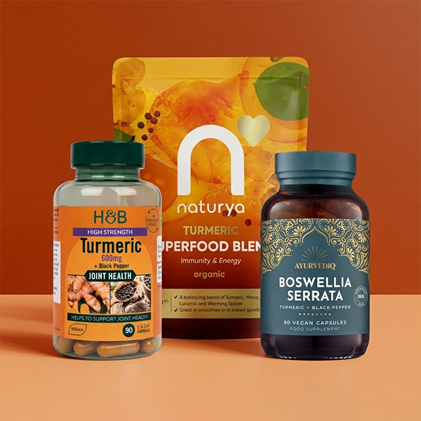 Selection of turmeric supplements on orange background