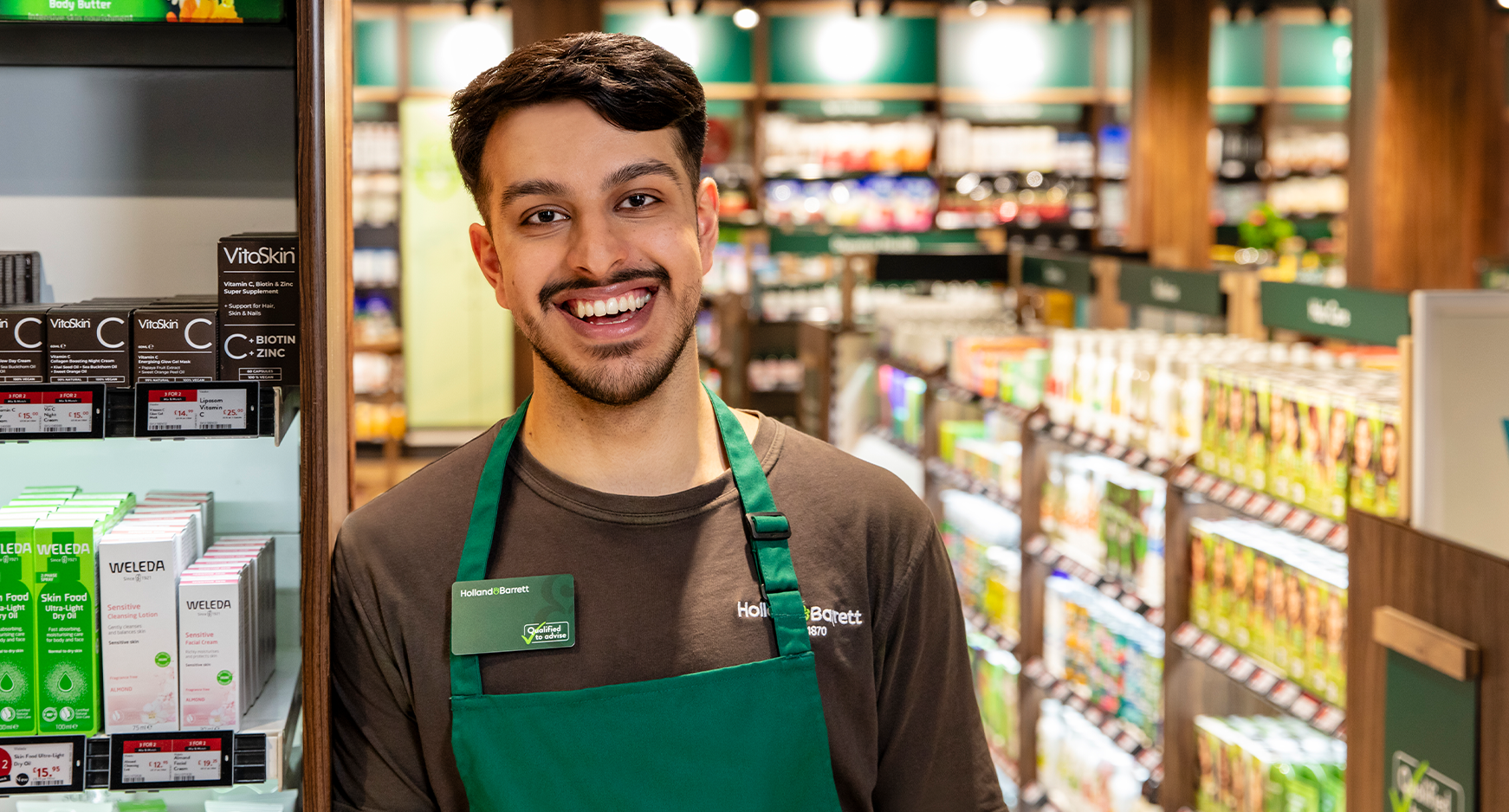 Male store colleague with happy expression