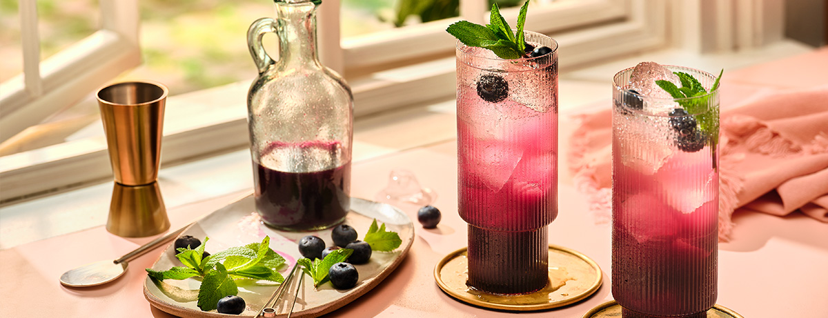 Glass of brain berry smoothie in kitchen background