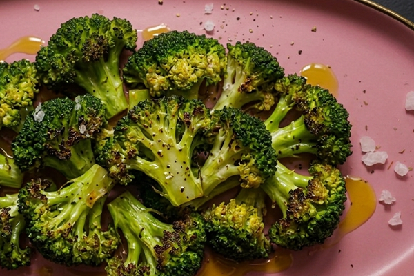 roasted broccoli on pink plate