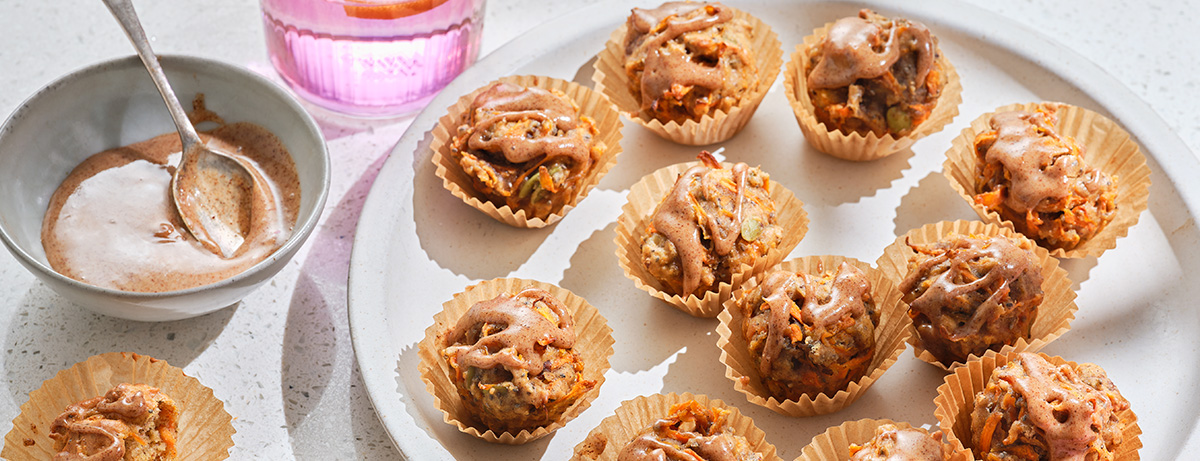 Carrot cake bite cupcakes sitting on white tray