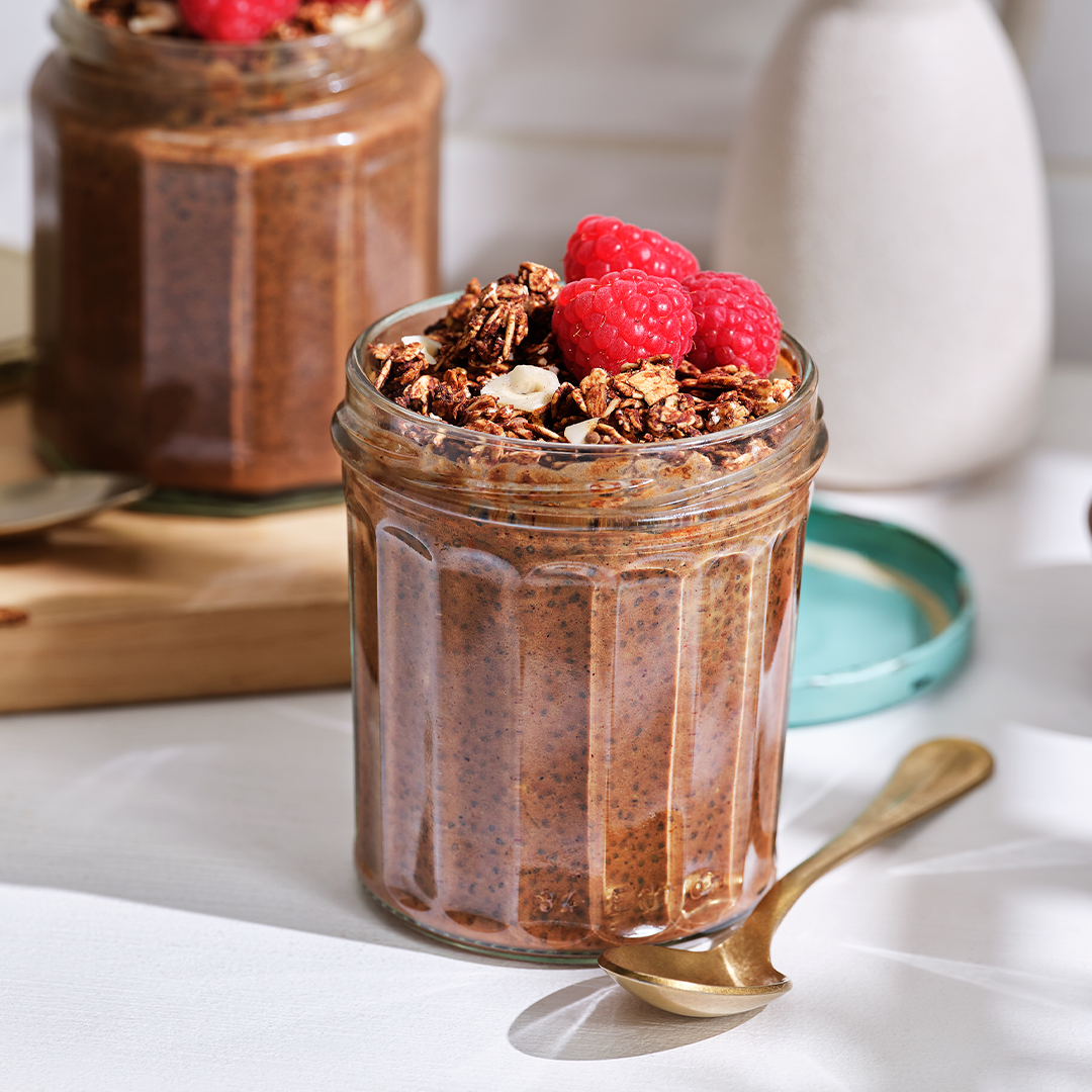 Jar of chia pudding with berries and seeds