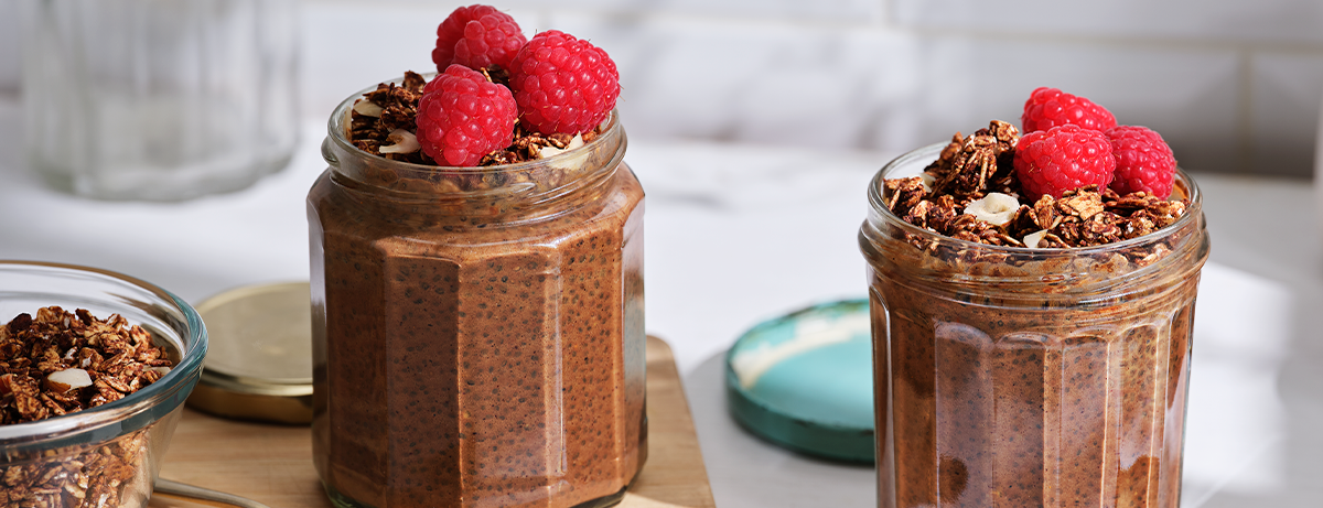 Jar of chia pudding with berries and seeds