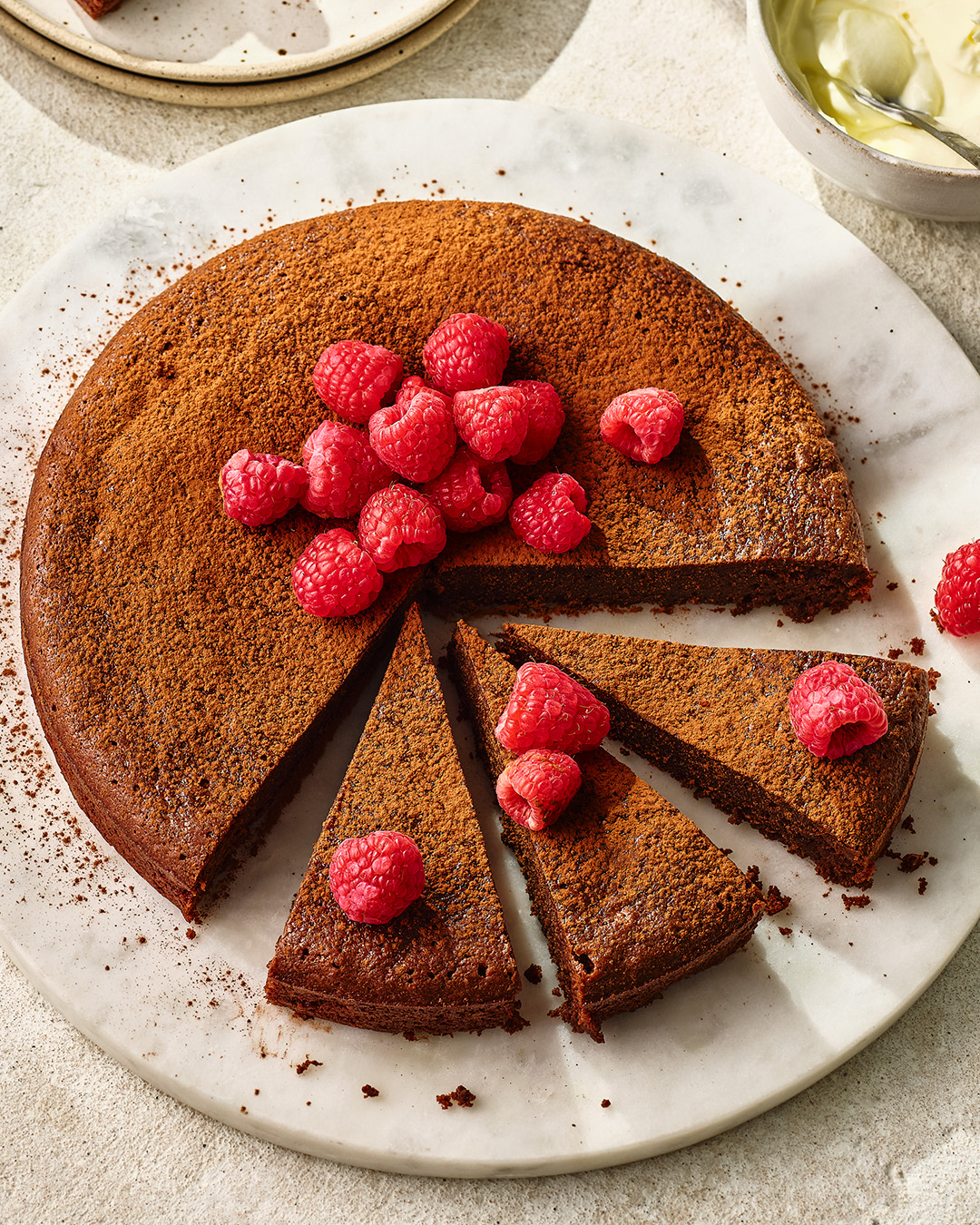 Chocolate torte on white plate cut up into slices