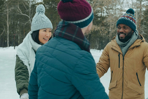 friends having a snowy walk at winter