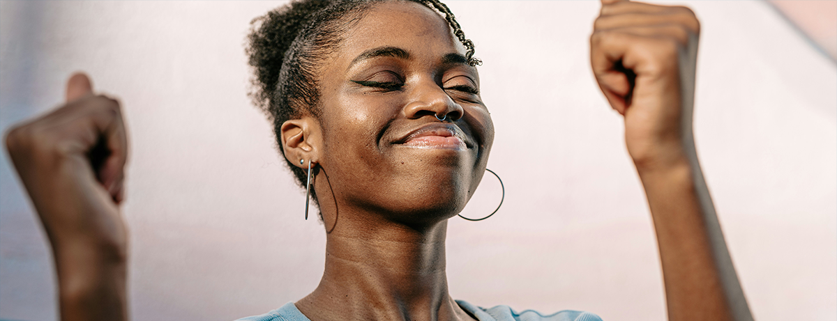 Female standing towards the wall with happy expression