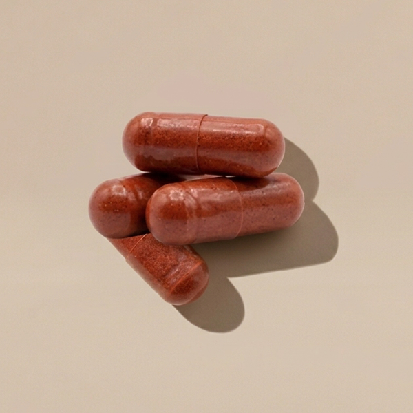 5 red supplements on a beige background