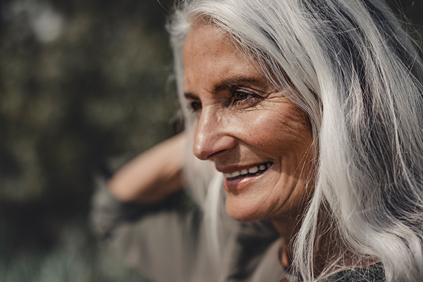 Older female outdoors with happy expression