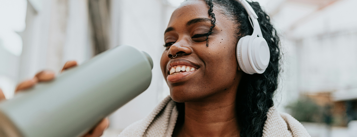 Female in workout clothes drinking from a sports flask