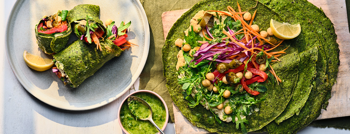 Spinach wrap with filling on a white background