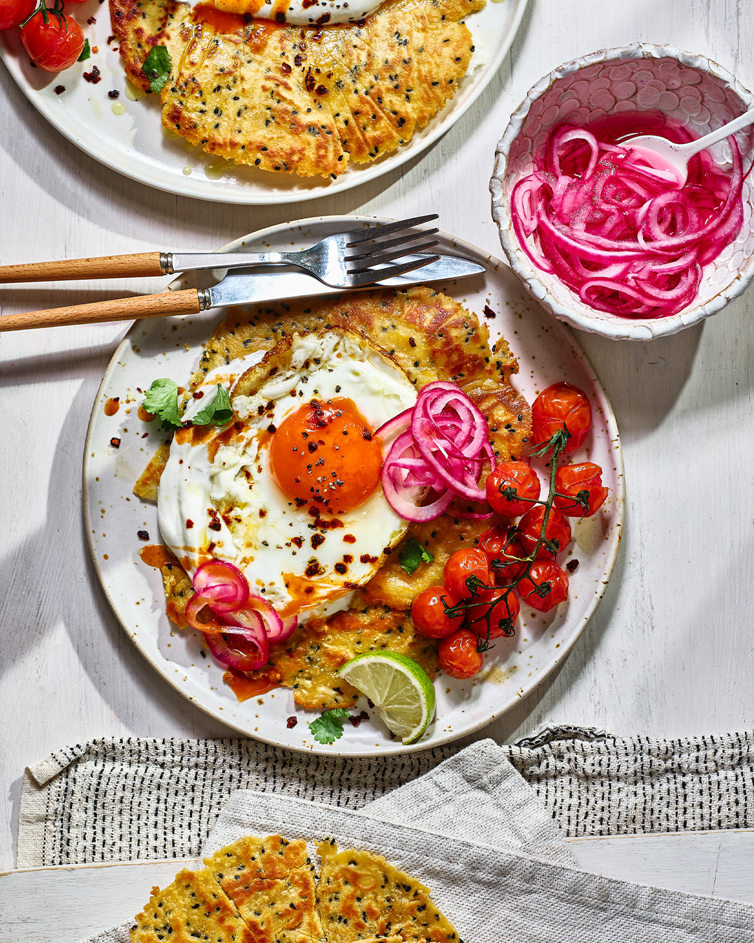 Gluten free flatbread on a white plate with a fried egg