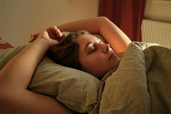 female laying in bed asleep