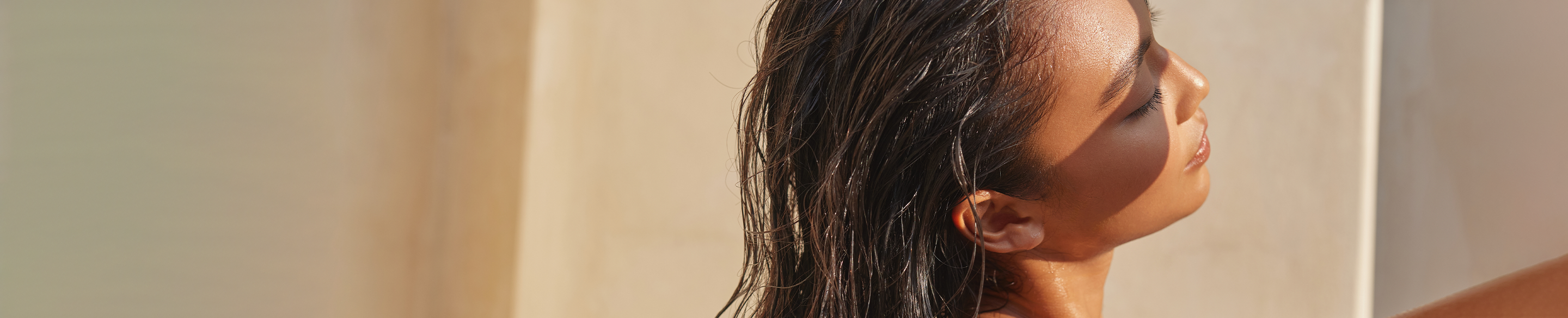 Woman With Wet Hair In Sunlight, Relaxed And Serene