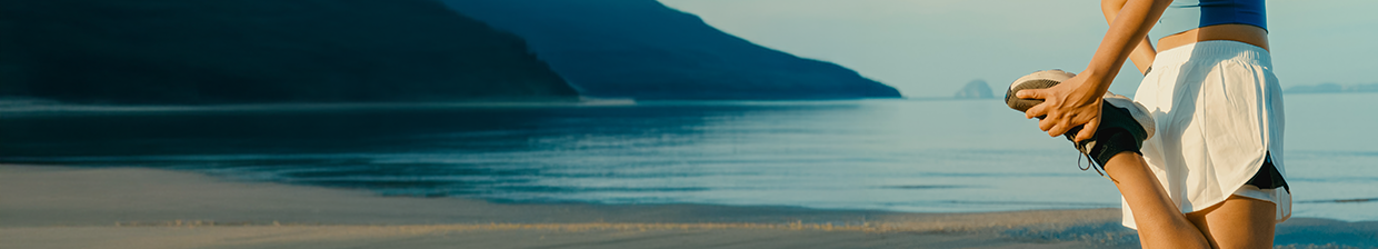runner stretching on the beach