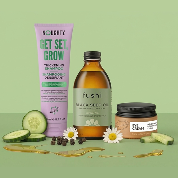 Selection of beauty products on green background