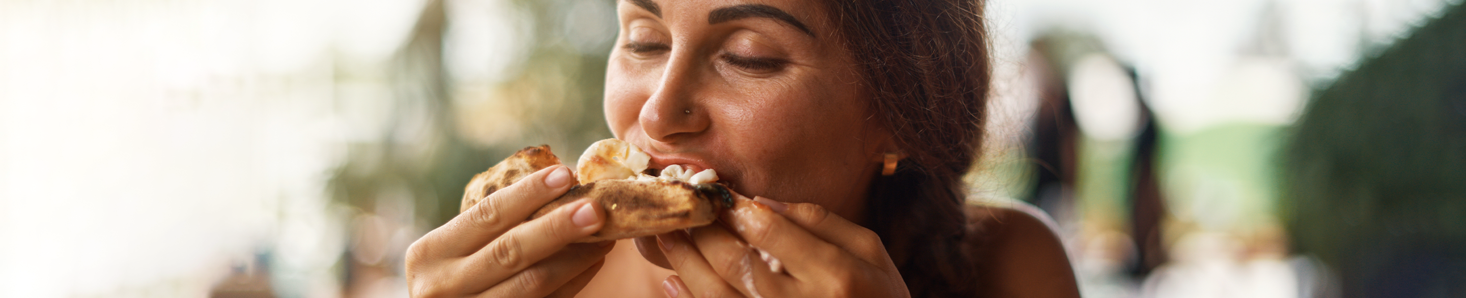 Female eating a gluten free sandwich, close up shot.