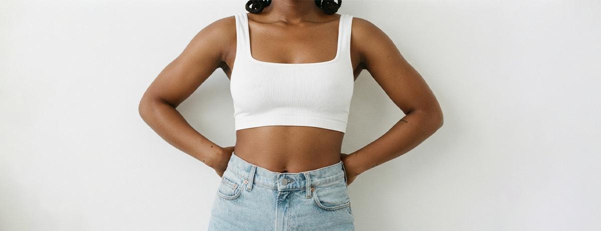 Female leaning against a white wall