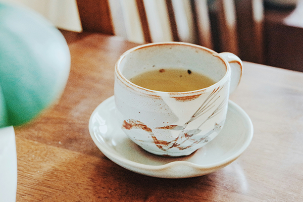 green tea in a white cup on a table