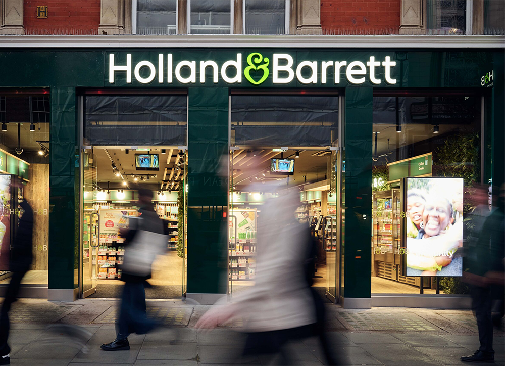 holland and barrett store with customer passing outside