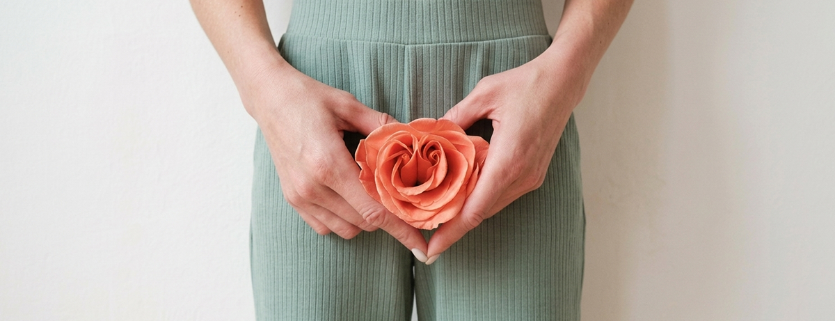 Female standing with flower in front of waist