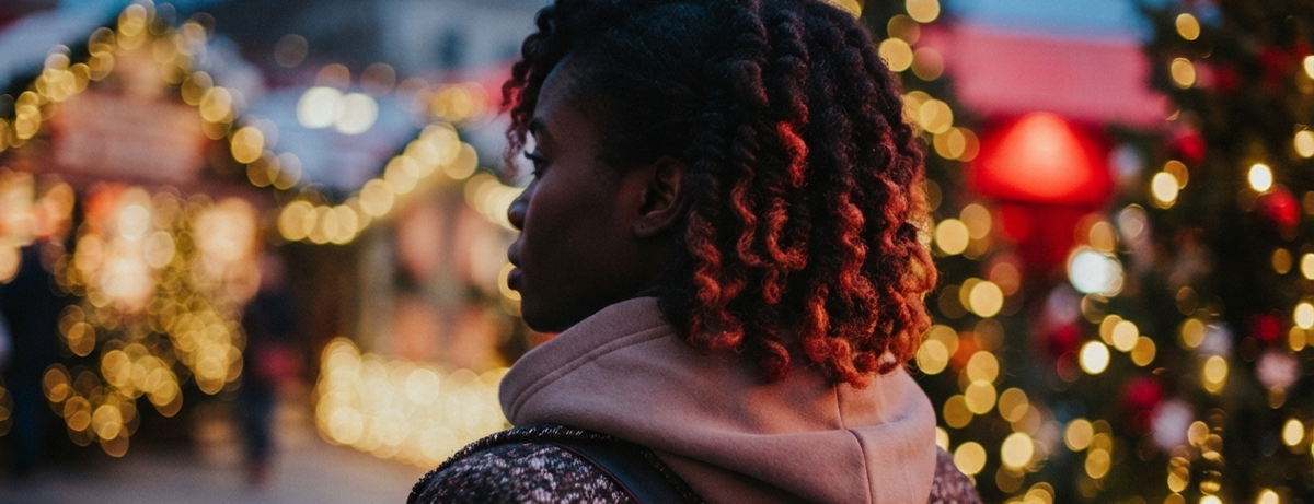 female in christmas market with back towards camera