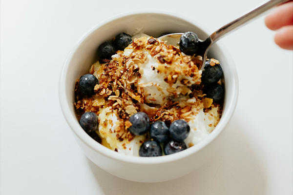 Yoghurt and granola in a white bowl
