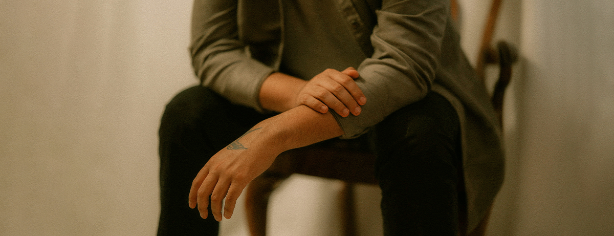Close up of male sitting on chair