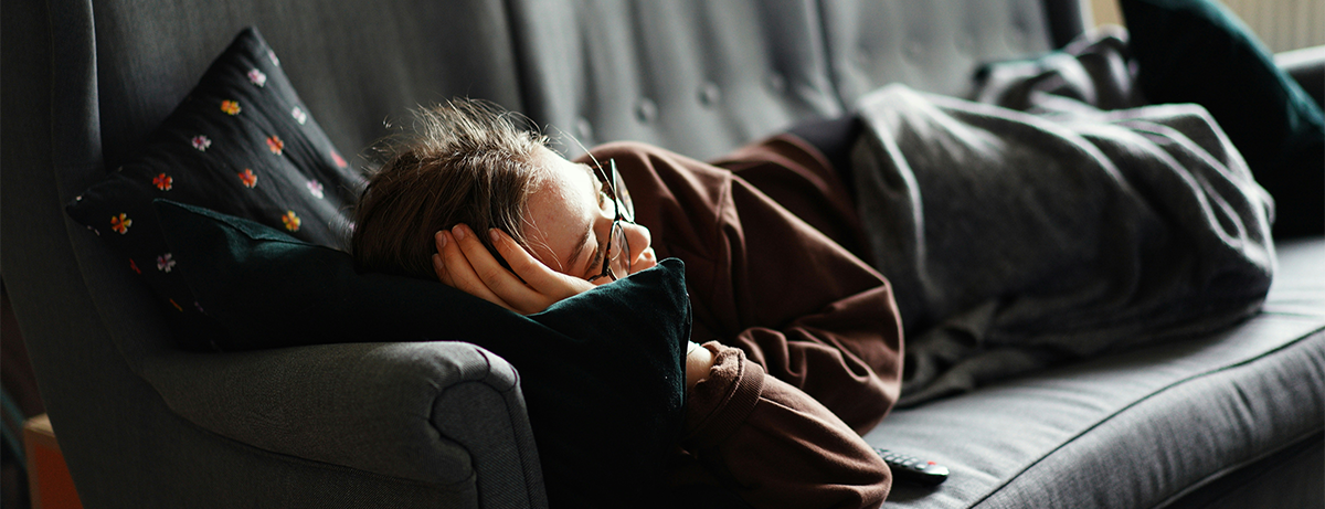 Female laying on sofa with calm expression
