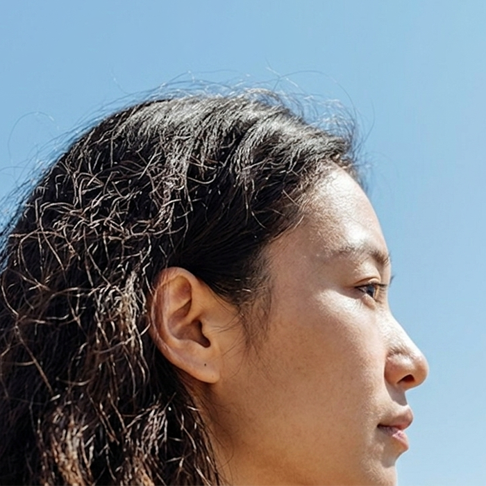 Close up of asian lady with blue sky background