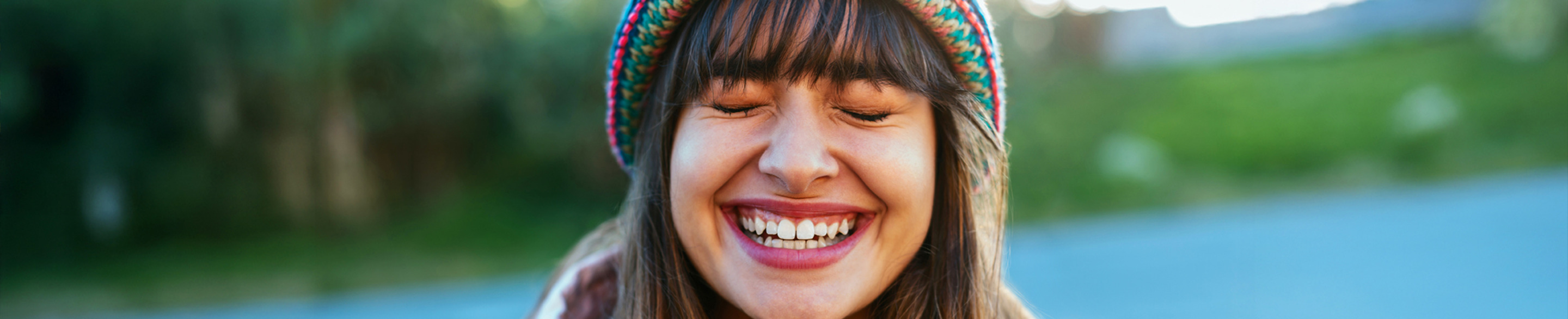 Female in winter hat smiling at the camera