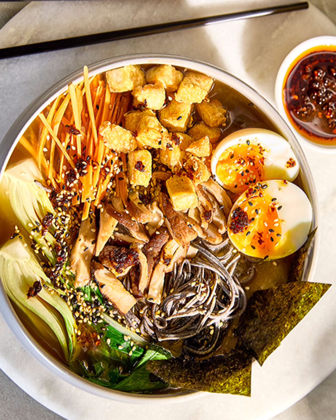 Tofu stir fry in bowl on kitchen worktop