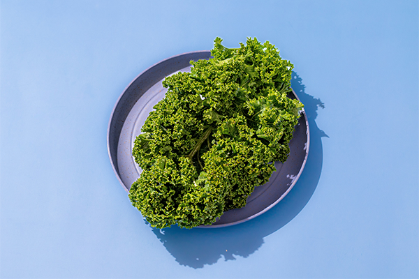 Portion of crispy kale on a purple dish