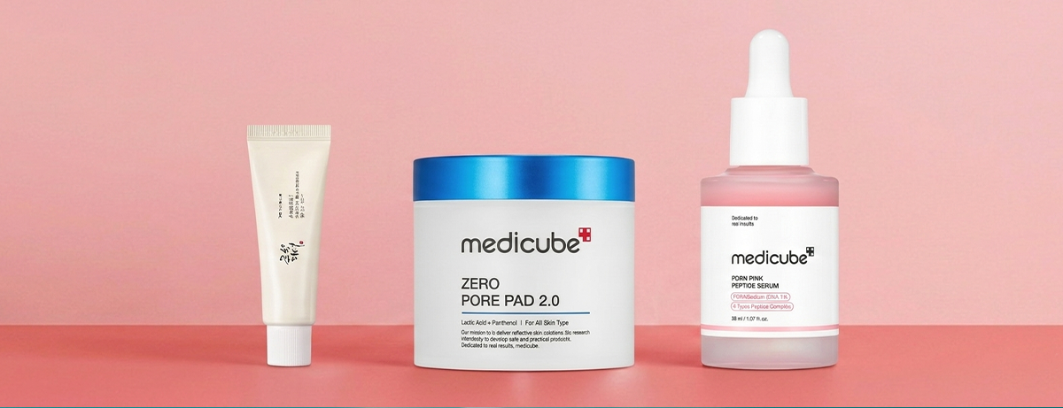 Selection of beauty products on pink background