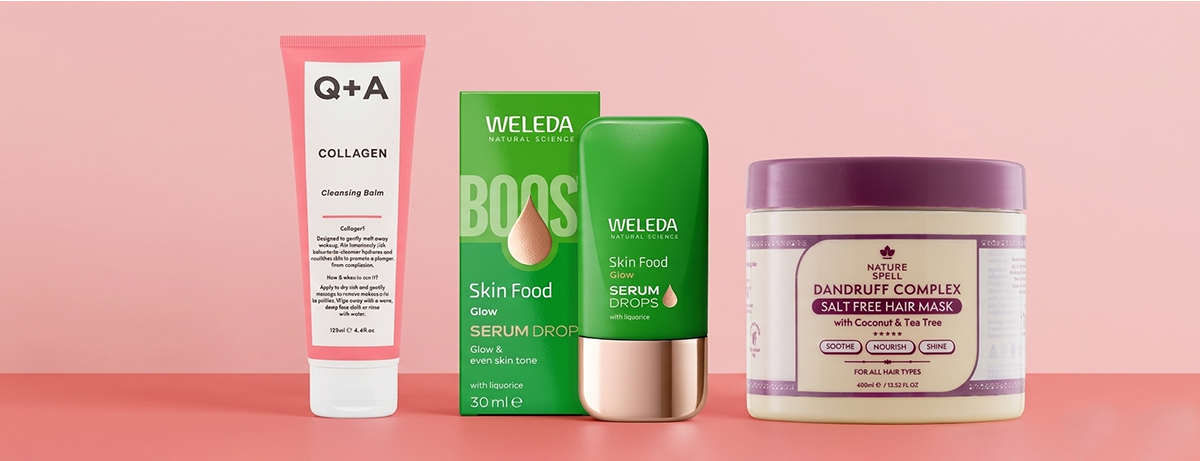 Selection of beauty products on a pink background