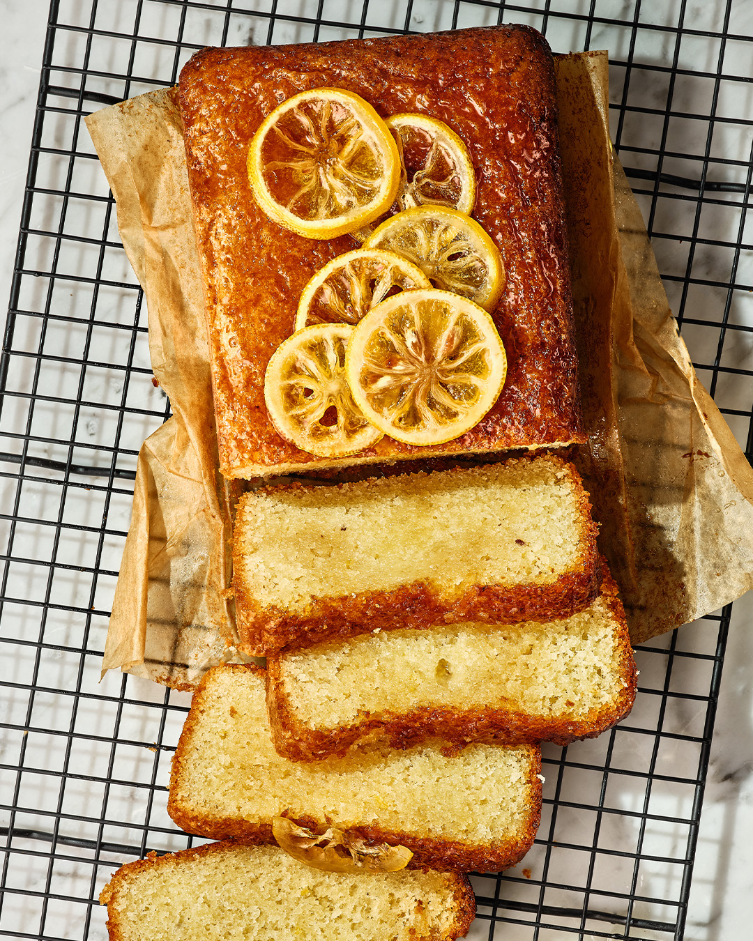 Lemon drizzle slice resting on a wire cooling tray