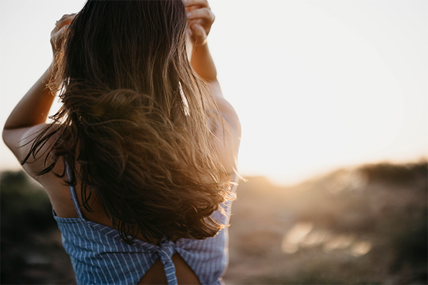 Female looking out at view hands in hair