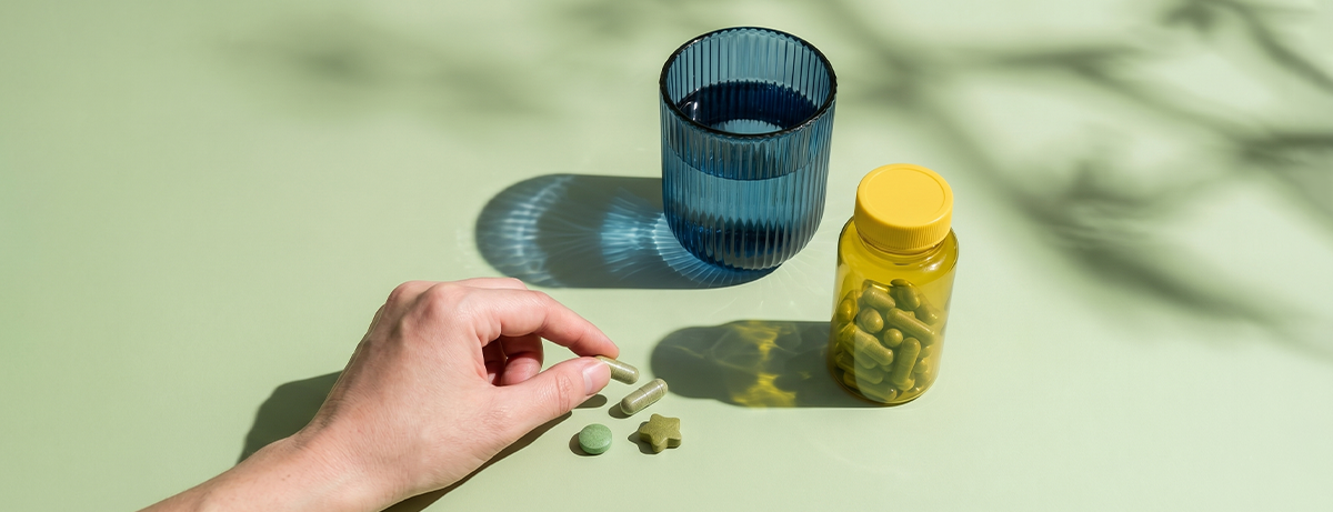 Selection of magnesium tablets on a green background