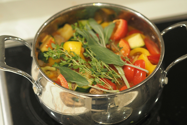 Vegetables sitting in a pot waiting to be cooked