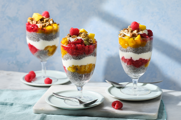 Mango and chia pudding in a glass on a grey background