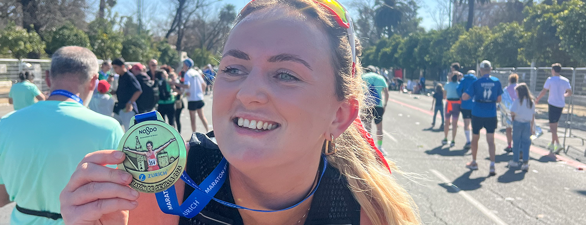Marathon runner posing with medal