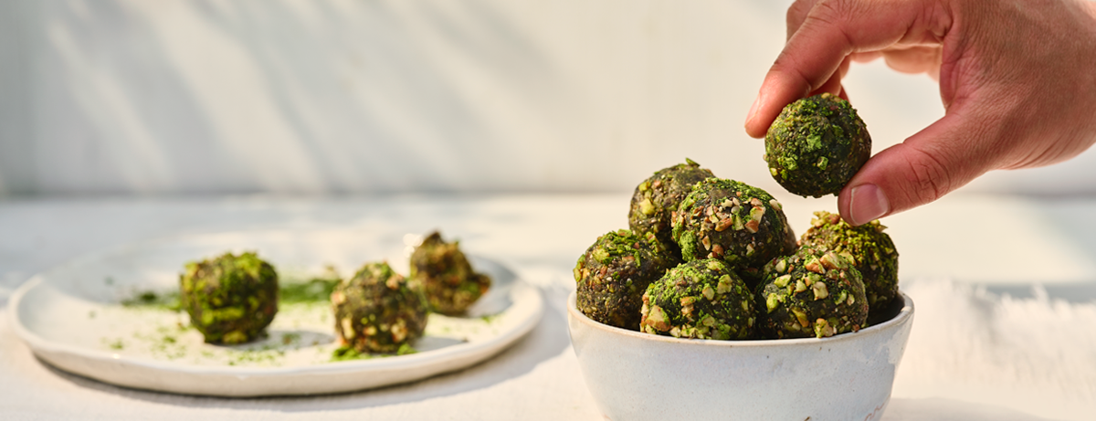 Portion of matcha energy balls on a white plate