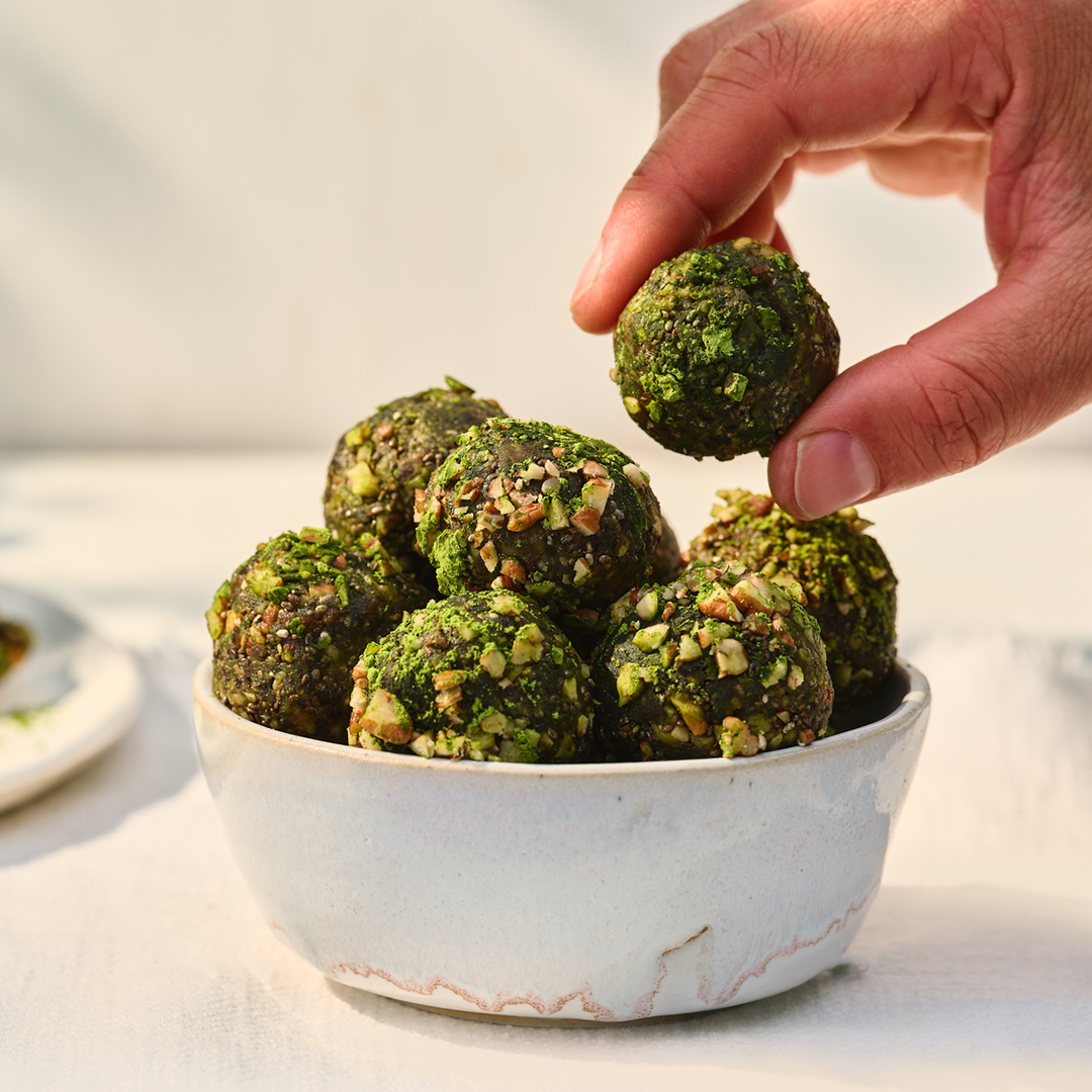 Portion of matcha energy balls on a white plate
