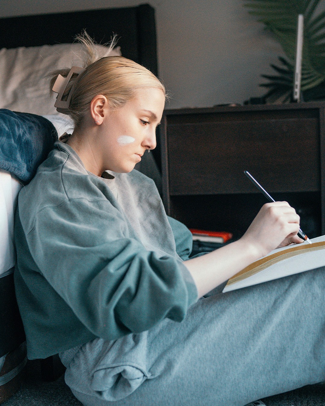 Female sitting on the floor painting