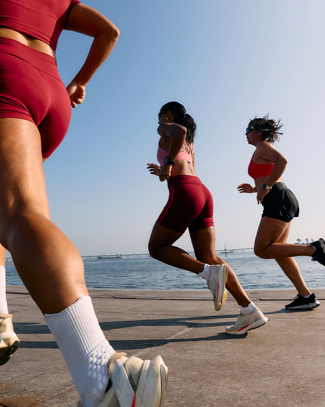 Group of runners running along the beach