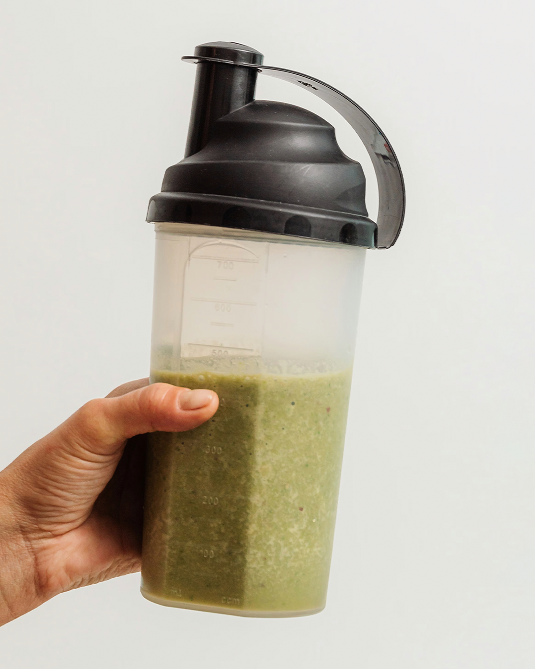 Hand holding protein shake