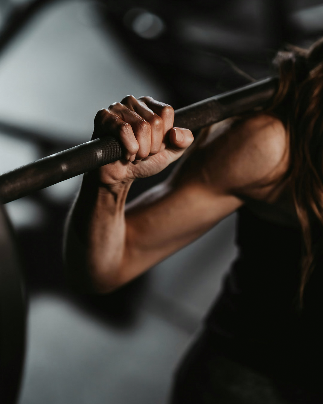 Female using squat rack at the gym