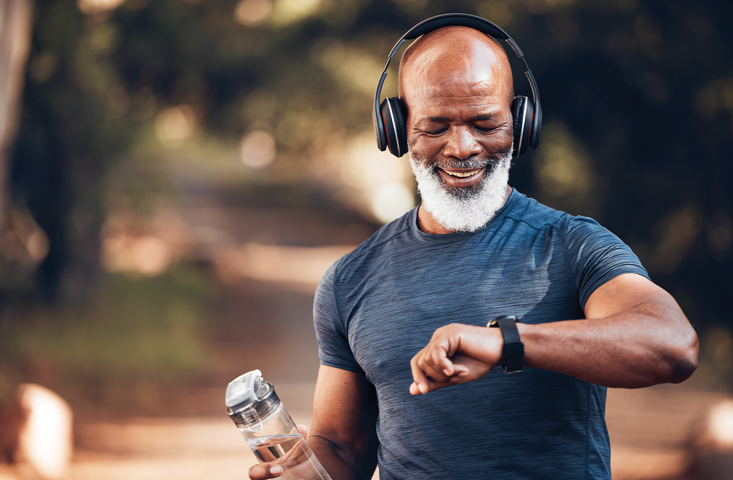 Male running in the park with a bottle of water