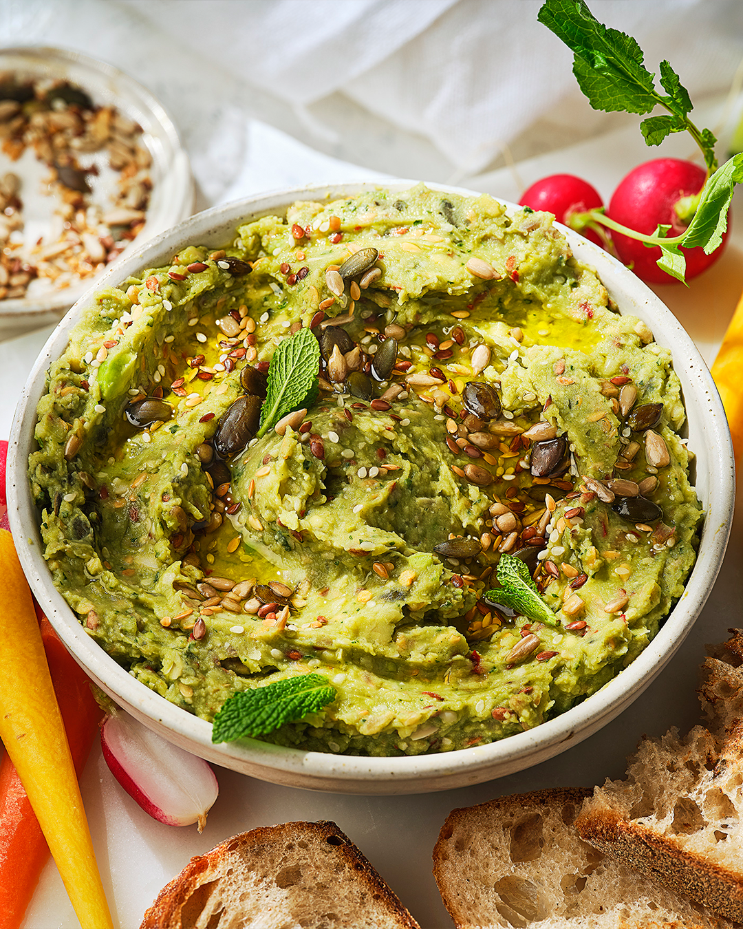 High fibre super bean dip on a table next to some sliced bread
