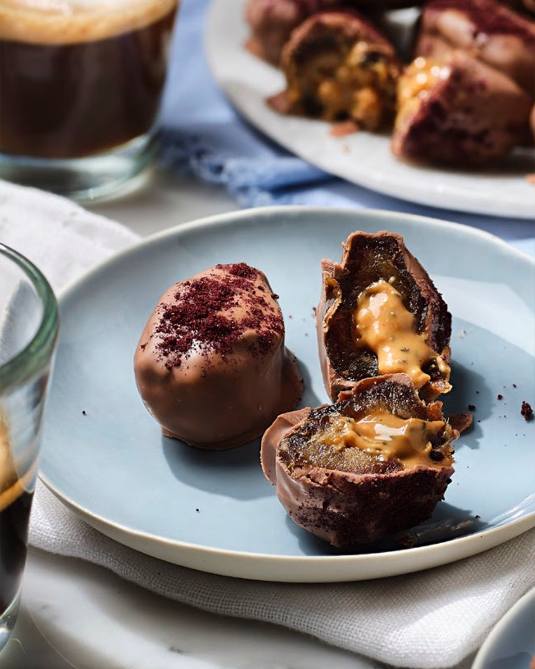 Portion of date chocolate bites on a blue dish